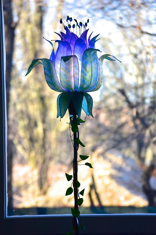 lampada da terra con paralume in resina ispirato alle piume di pavone blu e viola