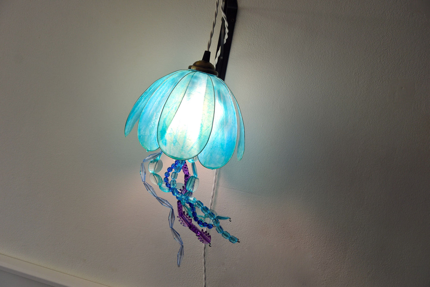 lampada a forma di medusa in resina da appendere alla parete, dipinta a mano